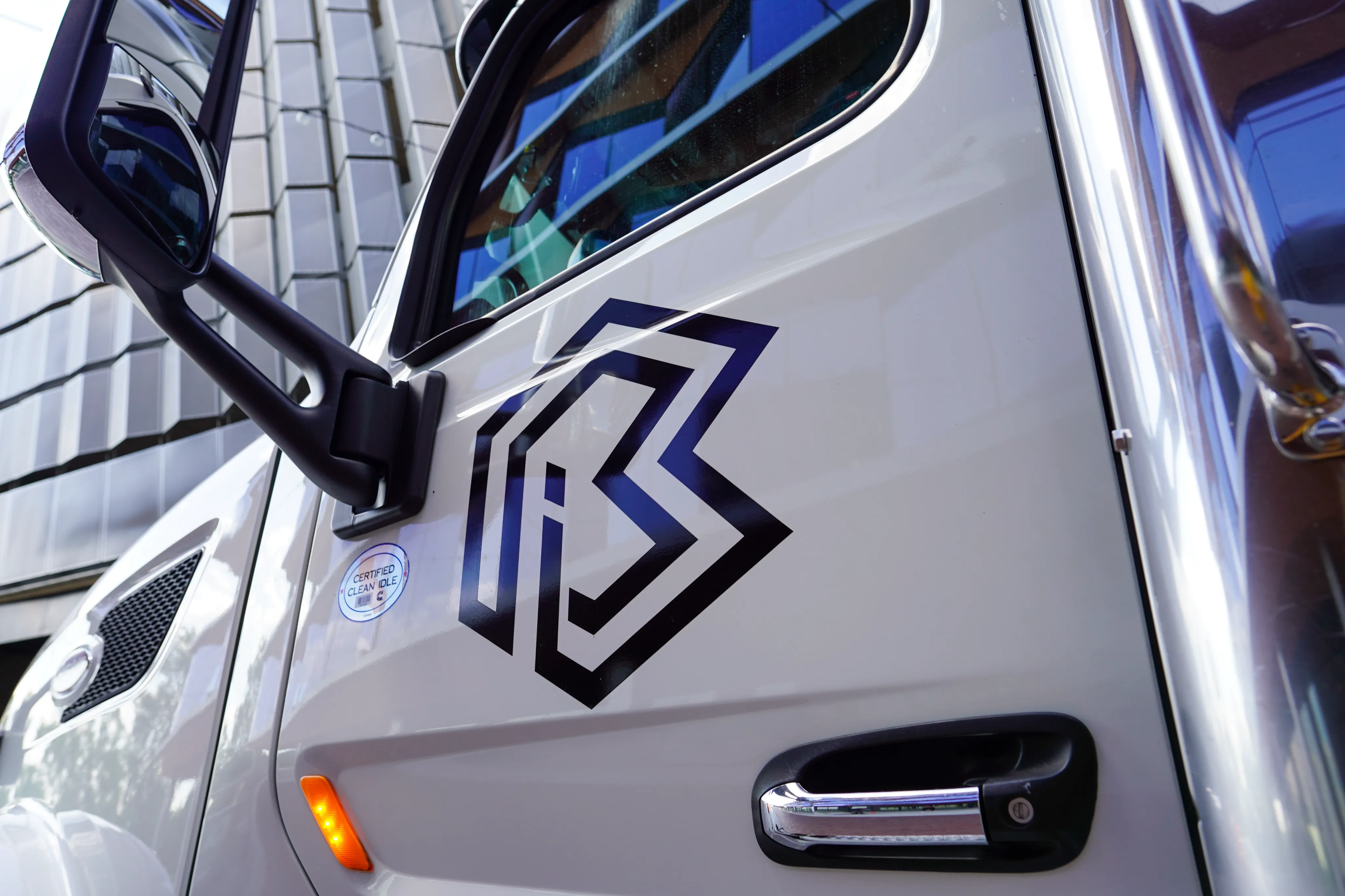 Close-up view of the BBI logo on a truck.