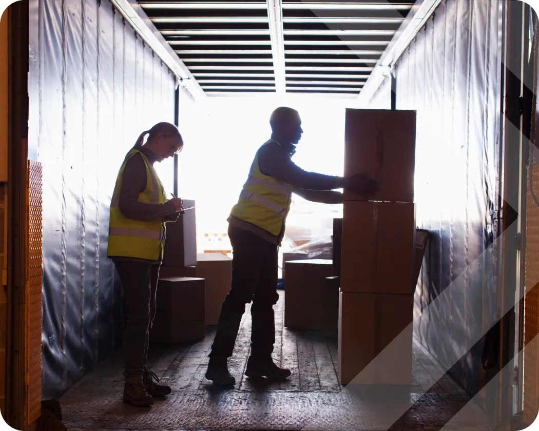 Workers loading a truck with boxes.