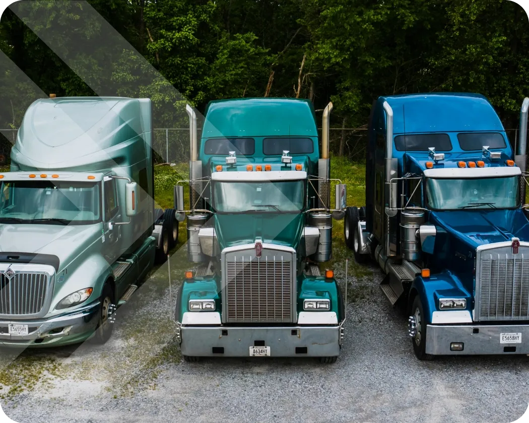 A front view of semi-truck tractors lined up.